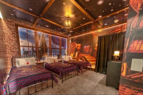 a bedroom with two beds and a room with a star ceiling at Experience Luxury In Your 11 En-suites Mansion in Orlando