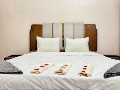 a bed with two sets of four towels on it at Spacious 3BR Maadi Stay Close to Nile Corniche in Cairo