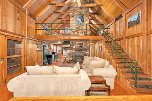 a living room with couches and a staircase in a cabin at Rustic Knotty Pine - Old Cabin Vibes in Shaver Lake