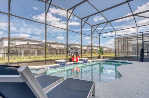 a large swimming pool with a gym in a building at Experience Luxury In Your 11 En-suites Mansion in Orlando
