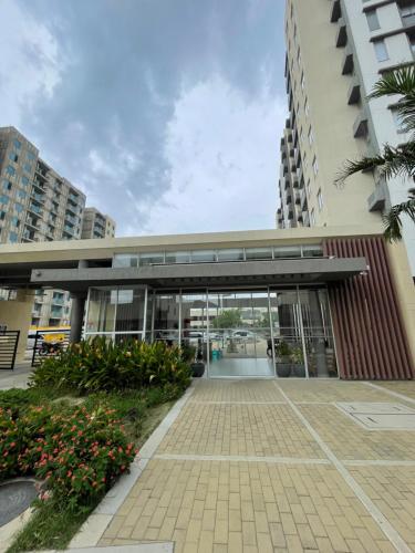 a building with a glass door and flowers in front at Tercer Cielo en Flamingo in Barranquilla
