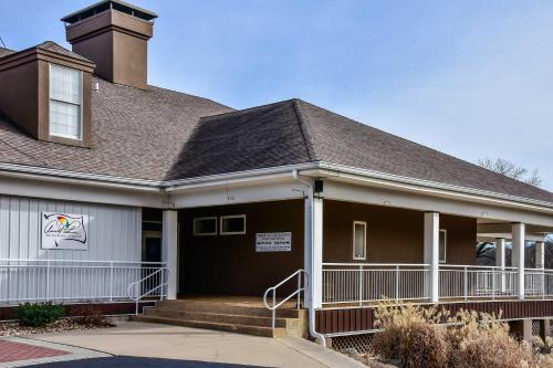 a house with a porch and a roof at Birdie's Bliss 2BR Condo Sleeps 6 in Lake Ozark