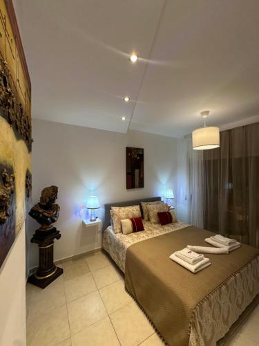 a bedroom with a bed with two towels on it at Luxury Living SKG 2 in Thessaloniki