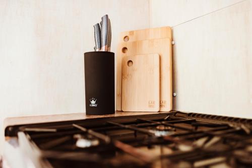 a kitchen stove with a knife and a knife block at Villa Hexengericht in Thale
