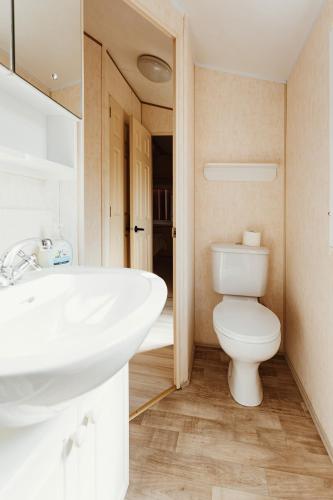 a bathroom with a white sink and a toilet at Villa Hexengericht in Thale