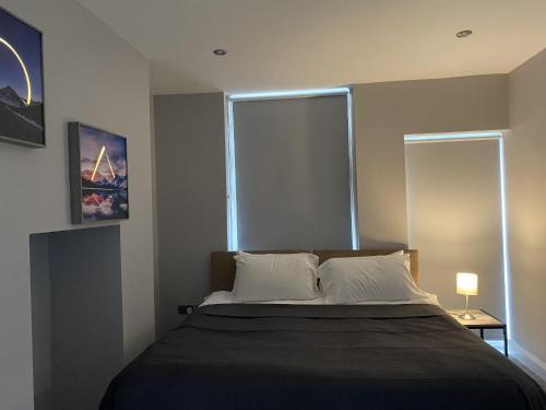 a bedroom with a bed with a large window at Chic Maidstone getaway in Maidstone
