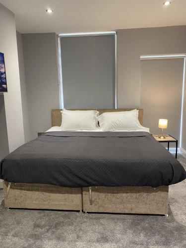 a bedroom with a large bed with a large window at Chic Maidstone getaway in Maidstone