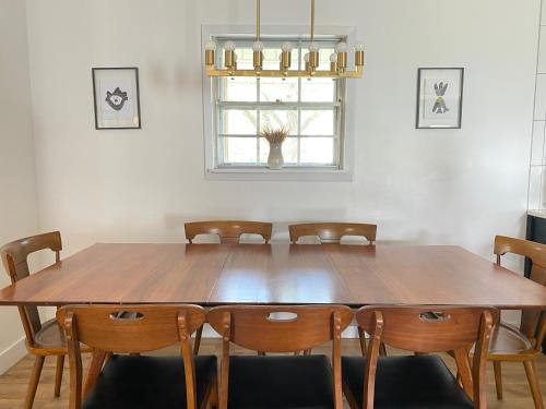 a dining room with a wooden table and chairs at The Parkway House in Bryan