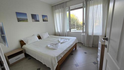 a bedroom with a bed and a window at Top privacy Eco Villa of 2023 @ TEG hill Tirana in Tirana