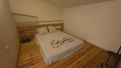a small bed in a small room with wooden floors at Top privacy Eco Villa of 2023 @ TEG hill Tirana in Tirana