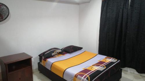 a bedroom with a bed with two bags on it at casa de relajacion lowcost in La Dorada