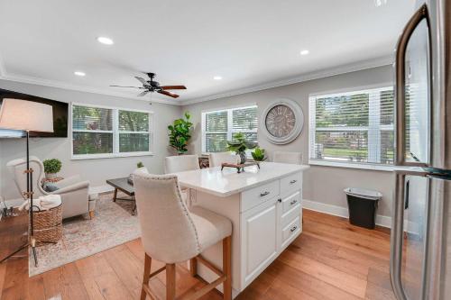 a kitchen with a white counter and a living room at Remodeled Downtown Apartment #1 in West Palm Beach