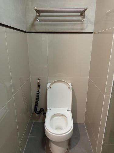 a bathroom with a toilet in a stall at Buena Casa Hotel in Olongapo