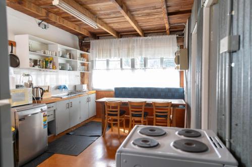 a kitchen with a stove and a table with chairs at Girraween Country Inn in Ballandean