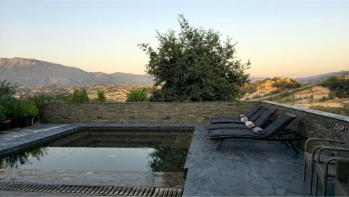 a bench sitting next to a pool of water at Top privacy Eco Villa of 2023 @ TEG hill Tirana in Tirana