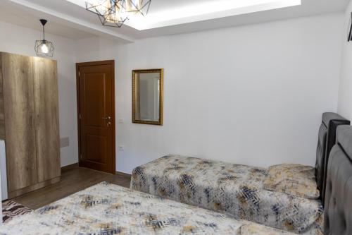 a living room with a couch and a mirror at Apartments Ceka in Ulcinj