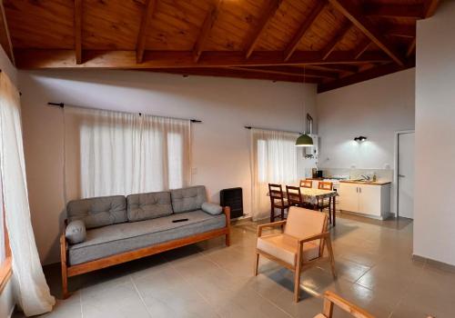 a living room with a couch and a table at Los Robles Patagonia in Esquel