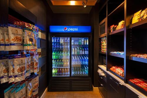 a soda machine in a grocery store with drinks at Courtyard by Marriott Baldwin Park in Baldwin Park