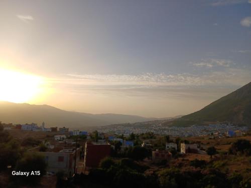 a view of a city at sunset at Casa laila in Chefchaouene