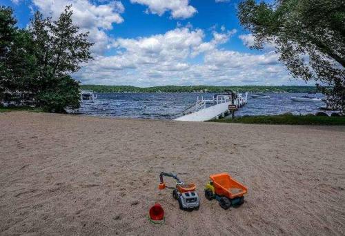 a toy truck on the beach next to the water at Briarwood Serenity at Abbey Springs - Quiet 4 BDR in Lake Geneva