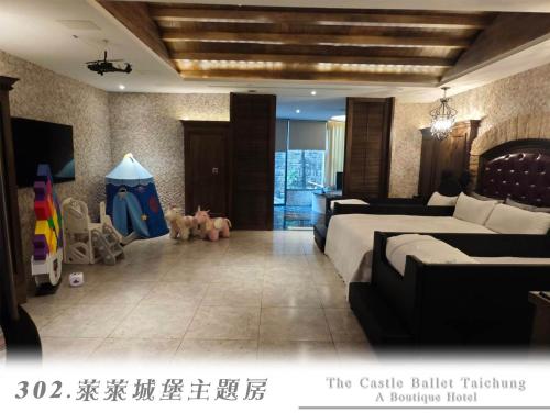 a bedroom with a bed and a room with a table at The Castle Ballet Taichung A Boutique Hotel in Taichung