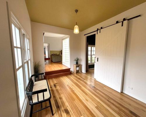 an empty living room with a sliding barn door at Phillip Island Coastal Cabins in Sunderland Bay