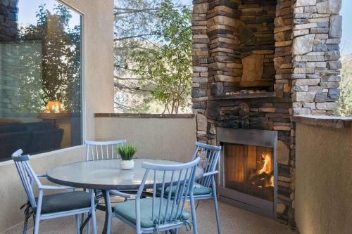 a patio with a table and chairs and a fireplace at Sierra Sky - Patio with fireplace in Hurricane