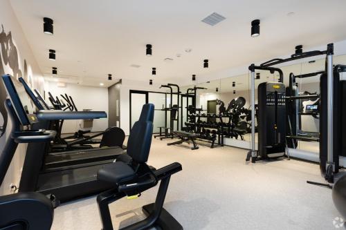 a gym with treadmills and machines in a room at Westwood Penthouse 3 Bedroom 2 Bath w Gym, Balcony, Parking in Los Angeles