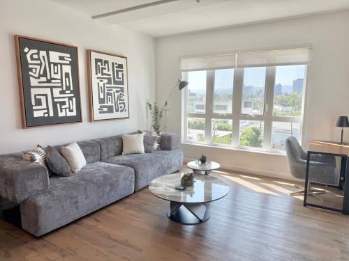 a living room with a couch and a table at Westwood Penthouse 3 Bedroom 2 Bath w Gym, Balcony, Parking in Los Angeles