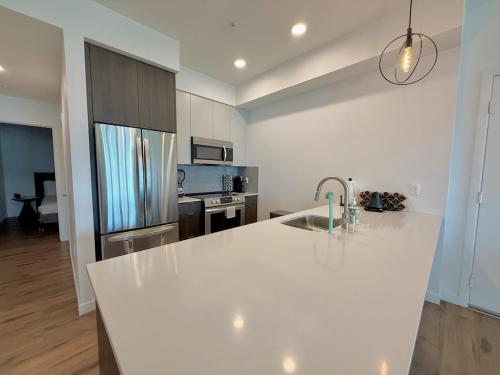 a kitchen with a white counter and a sink at Westwood Penthouse 3 Bedroom 2 Bath w Gym, Balcony, Parking in Los Angeles