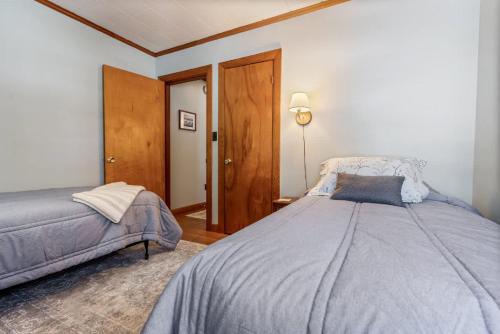 a bedroom with a bed and a lamp in it at Beachfront Just steps and you're on the beach in Saco