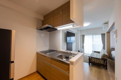 a kitchen with a sink and a counter top at Tomattoco KASUMI in Yamagata