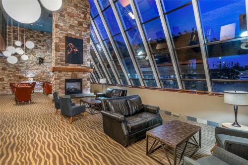 a lobby with leather chairs and a fireplace at Best Western The Westerly Hotel in Courtenay