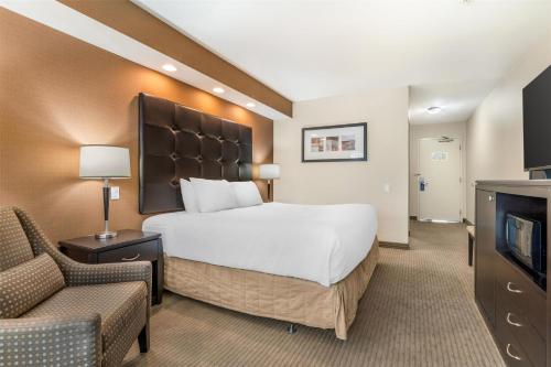 a hotel room with a bed and a couch and a tv at Best Western The Westerly Hotel in Courtenay
