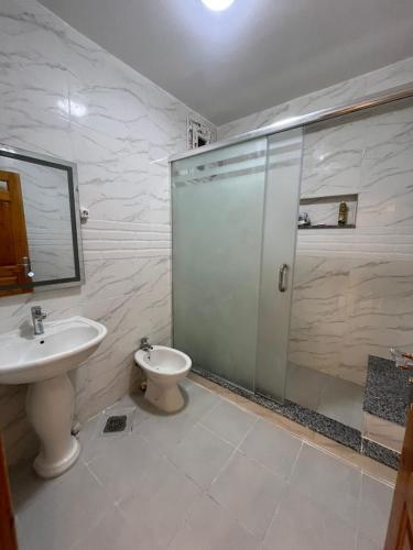 a bathroom with a shower and a sink and a toilet at Ain Taya residency in 'Aïn Taya