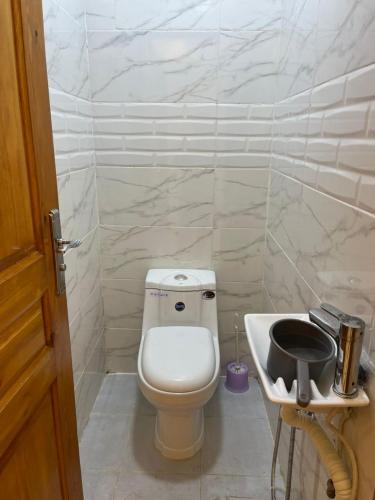 a small bathroom with a toilet and a sink at Ain Taya residency in 'Aïn Taya