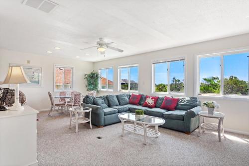 a living room with a couch and a table at 1702 - Sandpiper Lookout in Poplar Branch
