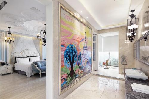 a bedroom with a large painting on the wall at The Castle Ballet Taichung A Boutique Hotel in Taichung