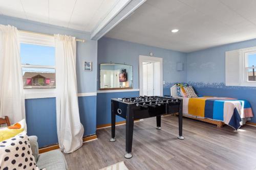 a bedroom with a bed and a table in it at 4119 - The Dolphin Boat in Kitty Hawk