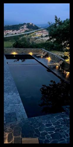 a reflection of a pool of water with a bench at Top privacy Eco Villa of 2023 @ TEG hill Tirana in Tirana