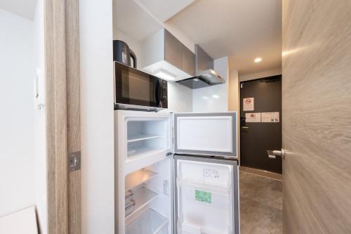 a refrigerator with its doors open in a room at ZAITO Waseda Terra Hotel in Tokyo