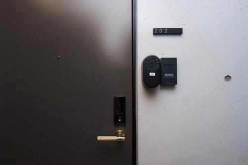 an open door with a lock on it at ZAITO Waseda Terra Hotel in Tokyo