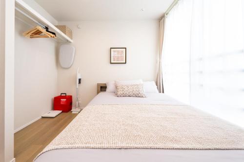 a bedroom with two beds and a window at ZAITO Waseda Terra Hotel in Tokyo