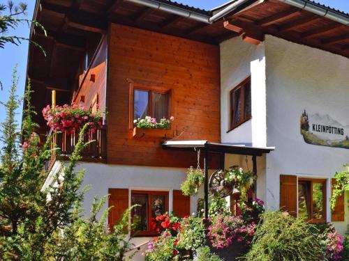 a house with flower boxes on the windows at Apartment in Hüttau near Ski Amadé Slopes in Hüttau