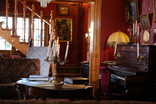 a living room with a table and a piano at Boutique Hotel Premium Vendimia in Santa Cruz