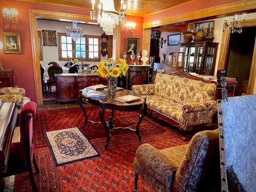 a living room with couches and a table with flowers at Boutique Hotel Premium Vendimia in Santa Cruz