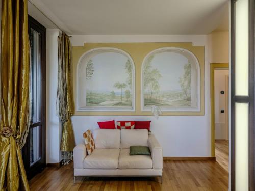 a living room with a white couch and two windows at Luxury large pool villa in Tolentino in Tolentino