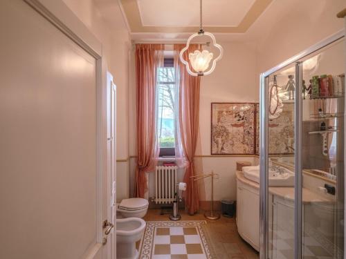 a bathroom with a toilet and a sink and a window at Luxury large pool villa in Tolentino in Tolentino