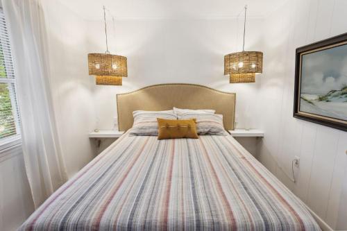 a bedroom with a bed with two pillows on it at 5041 - The Captains Quarters in Kill Devil Hills