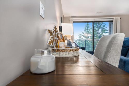 a dining room table with a bottle of wine on it at Beautiful Lake View Golf Course Condo in Traverse City